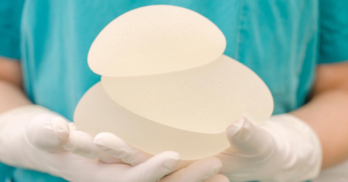 A doctor holds breast implants in Northbrook, IL.