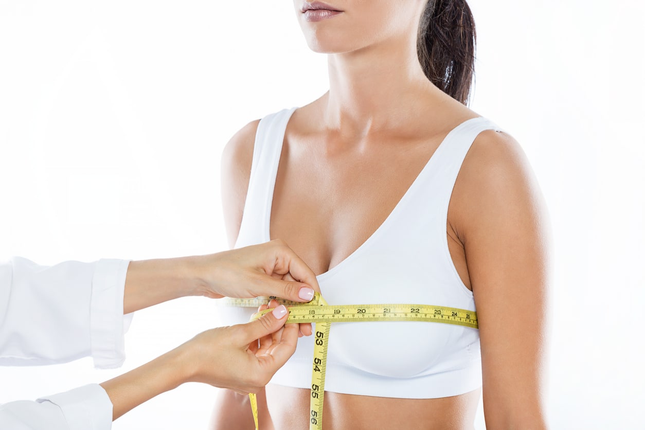 Woman having her breasts measured for breast reduction in Northbrook, IL